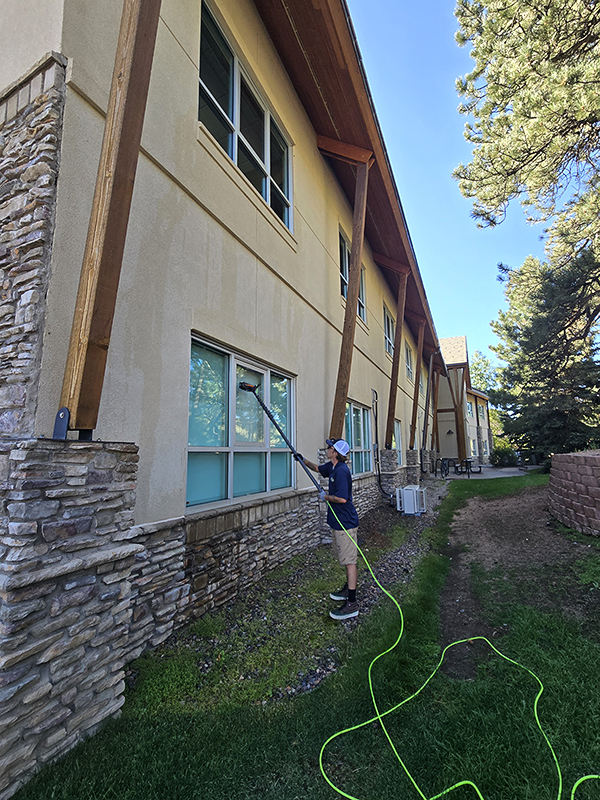 Photo: PEAK window washers use a waterfed pole at the Peak Office Building in Evergreen, CO.