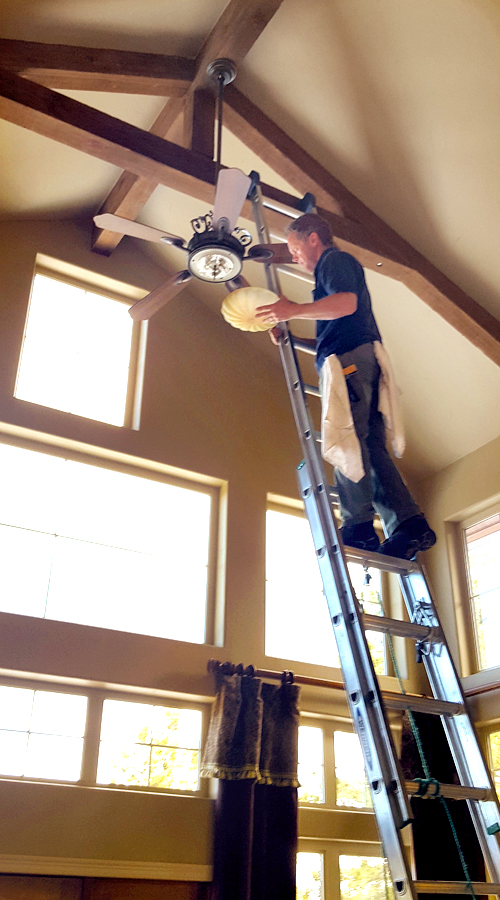 Photo: the PEAK team changing light bulbs that are up high.